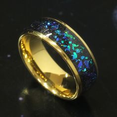 a gold ring with blue and green fire opal inlayed to the inside