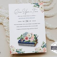 the wedding card has flowers on it and is next to an envelope that says, one upon time