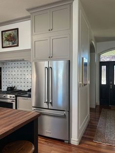 a kitchen with stainless steel appliances and wood floors