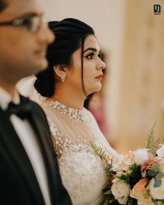 the bride and groom are looking at each other