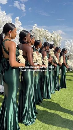 a group of women in green dresses standing next to each other