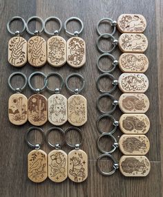 several wooden key chains with different designs on them