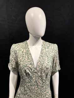 Such a pretty 1930s silk day dress in fantastic condition and with a gorgeous floral print. The fabric is silk so feels lovely to wear. The shape is very flattering with its panelled dropped waist. It fastens with press studs on the side and has been cleaned. Bust 40" Waist 32" Hips 44" Waist to hem 31" Shoulder to waist 16" Silk Midi Dress With Floral Print And Fitted Bodice, Vintage Floral Print Midi Dress With V-neck, Fitted Green Floral Vintage Dress, Fitted Green Vintage Dress With Floral Print, Vintage V-neck Fitted Midi Dress, Fitted Rayon Dresses With Bias Cut, Vintage Midi Dress With Fitted Bodice And Short Sleeves, Fitted Rayon Dresses In Bias Cut, Fitted Bias Cut Rayon Dresses