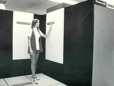 a woman standing in front of two white boards