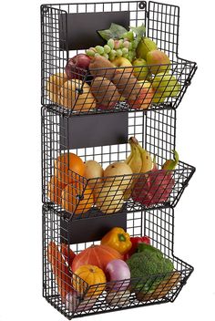 three metal baskets filled with different types of fruits and vegetables on top of each other