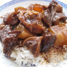 a blue and white plate topped with rice and beef