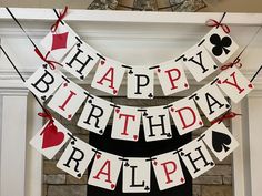 a happy birthday banner hanging from a fireplace