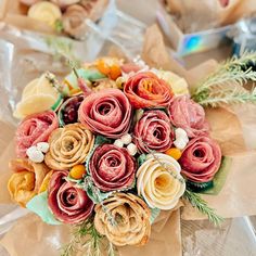 a bouquet of flowers sitting on top of a piece of wax paper next to other items