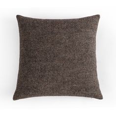 a brown and black pillow sitting on top of a white wall