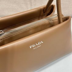 SHOP MORE LUXURY PRODUCTS HERE Description Prada Small Bag Brown For Women, Women’s Bags 9.8in/25cm Size: 25 x 13.5 x 13 cm /9.8 x 5.3 x 5 inches (Length x Width x Height) A study of the lines characterizes this smallÃƒÂ¯Ã‚Â¿Ã‚Â½ÃƒÂ¯Ã‚Â¿Ã‚Â½ÃƒÂ¯Ã‚Â¿Ã‚Â½ÃƒÂ¯Ã‚Â¿Ã‚Â½ handbag. It stands out for its absolutely elegant silhouette emphasized by the long, narrow handle. This three-pocket accessory is decorated with the metal lettering logo. BrownHandlesMetal hardwarePrinted lettering logo on the Designer Baguette Bag For Daily Use, Designer Handheld Baguette Bag, Luxury Double Handle Baguette Bag For Shopping, Designer Brown Baguette Bag With Top Carry Handle, High-end Baguette Bag With Removable Pouch, Designer Brown Baguette Bag With Top Handle, Daily Use Designer Satchel Baguette Bag With Dust Bag, High-end Baguette Shoulder Bag With Top Carry Handle, High-end Baguette Bag For Shopping