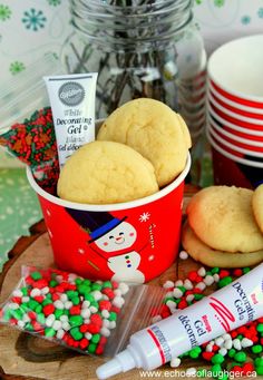 some cookies and candy are sitting on a tray next to other holiday treats, such as marshmallows