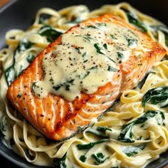 a close up of a plate of food with pasta and salmon on it's side