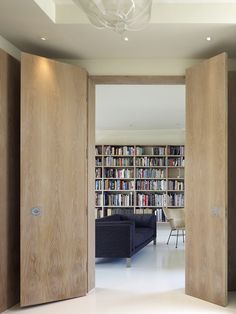 an open door leading to a living room filled with books