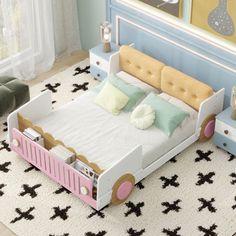 a child's bed with pink, yellow and white furniture in a bedroom setting