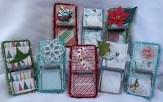 a group of different types of greeting cards on a white sheet with snowflakes