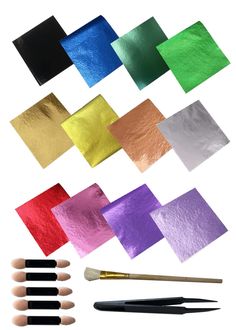 various colors of paint and brushes on a white background