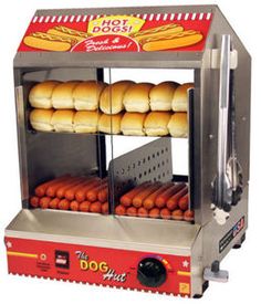 hot dogs are being cooked in an electric oven with buns on the rack and one is cooking