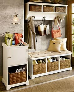 a white bench sitting next to a window filled with lots of bags and purses