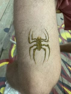 a man with a spider tattoo on his arm