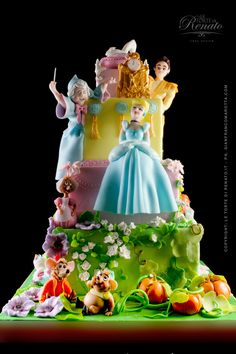 a three tiered cake with princess figurines on the top and other decorations