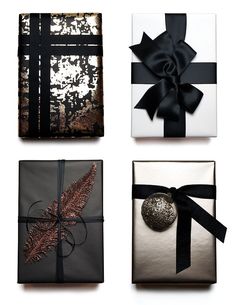 four wrapped presents with black and white ribbons