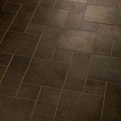 a white toilet sitting on top of a tiled floor