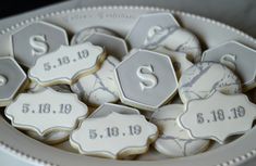 decorated cookies in the shape of hexagons with initials and date on them