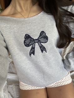 grey lace bow sweatshirt available in other sweatshirt and lace bow colours do not iron lace directly model wears size small with cut neckline fleece lined sweatshirt, unisex sizing please refer to size guide below: SMALL: chest- 34-36 inches width: 50.8 cm length: 71.1 cm sleeve length: 86.4 cm MEDIUM: chest- 38-40 inches width: 50.8 cm length: 73.7 cm sleeve length: 88.9cm LARGE: chest- 42-44 inches width: 61 cm length: 76.2 cm sleeve length: 91.4 cm EXTRA LARGE: chest- 46-48 inches width: 66 Grey Coquette, Princess Couture, Sweater Off The Shoulder, Deer Embroidery, Sweat Gris, Color Combos Outfit, Bow Boots, Coquette Style, Knitted Hood