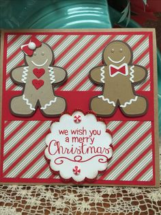 a christmas card with two gingerbreads on it