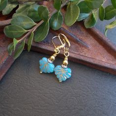 "Cute little woodland dangles - these nature-inspired drops feature detailed Czech glass leaf beads in a pretty ocean blue with a rustic gold finish. The beads are finished on both sides and paired with rhinestone and gold beads and gold plated lever back ear wires. Earring Size: about 1 1/2\" long including the ear wire Bead Size: 1/2\" Nature Collection https://www.etsy.com/shop/BonArtsStudio?ref=hdr_shop_menu&search_query=nature+earrings More Beaded Beauties: https://www.etsy.com/shop/BonArtsStudio?ref=seller-platform-mcnav&section_id=17052813 See What's New: https://www.etsy.com/shop/BonArtsStudio?ref=seller-platform-mcnav&section_id=23290134 My Shop Link: https://www.etsy.com/shop/BonArtsStudio Your earrings will arrive in a gift box with a pretty ribbon - ready for gift giving - whet Blue Leaf-shaped Jewelry For Gift, Blue Leaf-shaped Jewelry Gift, Nature-inspired Jewelry With Dangling Beads For Gifts, Handmade Blue Leaf-shaped Jewelry, Pretty Ocean, Pretty Ribbon, Leaf Beads, Earrings Nature, Nature Earrings