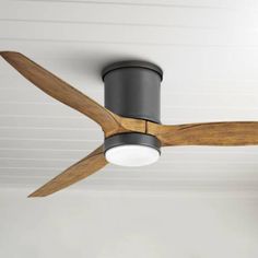 a ceiling fan that is mounted to the ceiling in a room with white walls and ceilings