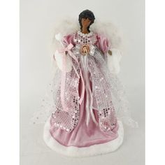 an angel figurine with white wings and pink dress