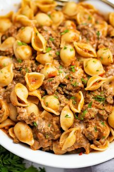 a white bowl filled with pasta and meat sauce