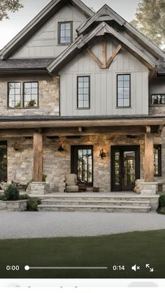 a large house with stone and wood accents