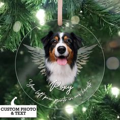 a christmas ornament with a dog's face and angel wings on it