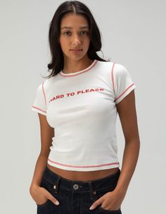 Bdg Urban Outfitters Hard To Please Baby Tee. "hard To Please" Screened Across Center Chest. Contrast Stitching. Ribbed Crew Neckline. Short Sleeve. 100% Cotton. Machine Wash. Imported. Model Is Wearing A Size Small. Model Measurements:height: 5'8" Bust: 32"waist: 24"hips: 35" Overalls Boys, Chino Pants Women, Wwe T Shirts, Character Fashion, Graphic Trends, Bdg Urban Outfitters, Boys Graphic Tee, Girls Graphic Tee, Girls Blouse