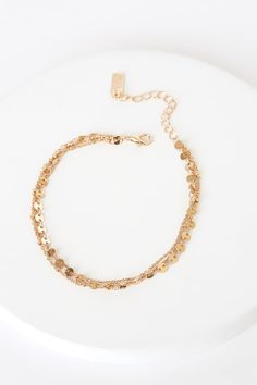 Lulus Exclusive! You'll love the delicate charm of the Lulus Dashing Gold Circle Charm Anklet! Three layers of dainty gold chain, accented with gold beads and circle charms, shape this simply stunning ankle bracelet. Lobster clasp closure. Ankle bracelet measures 8" long with a 2. 25" extender chain. Man Made Materials. Imported. Lulus | Dashing Gold Circle Charm Anklet. Dainty Gold Chain, Charm Anklet, Gold Circle, Ankle Bracelet, Anklet Jewelry, Ankle Bracelets, Gold Beads, Delicate Bracelet, Gold Chain