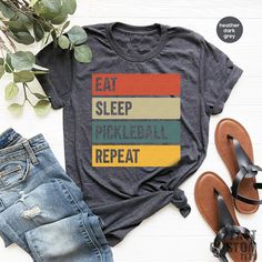 a t - shirt that says eat sleep pickleball repeat next to some sandals