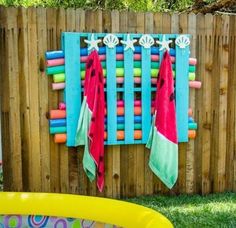 an inflatable pool with towels hanging on the wall and other items around it