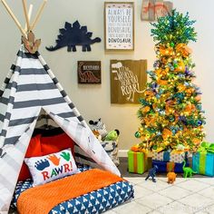 a teepee tent next to a christmas tree in a child's playroom