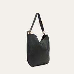 TOM FORD "Tara" crossbody hobo bag in leather, faux leather (polyurethane), and brass  Adjustable, detachable flat crossbody strap Open top with T-strap magnetic closure; zip closure  Lining: Polyurethane Approx. 15"H x 15.7"W x 1.6"D Item Weight (Lbs.): 1.9 Made in Italy Versatile Hobo Bag With Gold-tone Hardware, Modern Crossbody Hobo Bag With Metal Hardware, Everyday Versatile Hobo Bag With Metal Hardware, Versatile Everyday Hobo Bag With Metal Hardware, Workwear Hobo Bag With Metal Hardware Crossbody, Business Hobo Bag With Metal Hardware, Modern Hobo Bag With Gold-tone Hardware For Business, Versatile Formal Hobo Bag With Gold-tone Hardware, Versatile Leather Hobo Bag With Metal Hardware