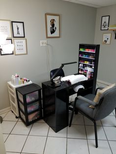 a chair and desk in a room with pictures on the wall behind it, along with other items