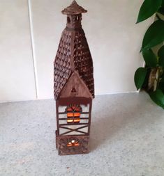 a small brown clock tower sitting on top of a counter