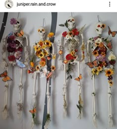 three skeletons with flowers and butterflies on them