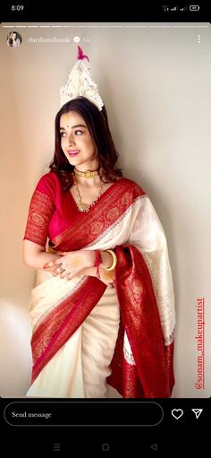 a woman wearing a red and white sari