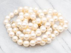 Indulge in the classic beauty of this saltwater pearl strand necklace. Each pearl has a lustrous shine and classic round shape. The strand is secured with a delicate yellow gold filigree clasp, adding a touch of warmth to this timeless piece. Elevate any outfit with this elegant necklace.Metal: 14K Yellow GoldGem: Saltwater PearlsGem Measurements: 8.4 mm, RoundLength: 33 InchesMarks: "14K G" Stamped on the clasp Classic Single Strand Pearl Necklace With Round Beads, Elegant High Luster Pearl Necklace, Classic Pearl Necklace Gift, Classic Formal Pearl Pendant Necklace, Classic Pearl Necklace As A Gift, Elegant Round Pearl Necklace With High Luster, Classic Pearl Necklace With Round Beads As Gift, Classic Pearl Necklace With Round Beads, Classic Formal Pearl Necklace With Pearl Drop