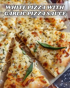 white pizza with garlic and sage on a cutting board