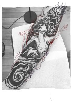 a woman's arm is covered in black and white ink with swirls on it