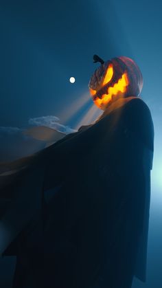 a person with a jack - o'- lantern on their head is standing in the dark