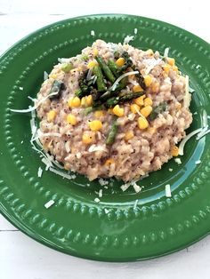 a green plate topped with rice and vegetables